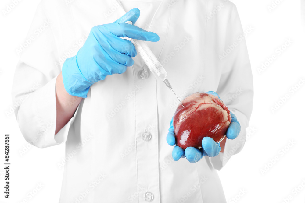 Heart with syringe in doctor hands isolated on white