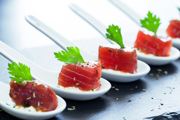 Wall Mural - Tuna appetizers on ceramic spoons.