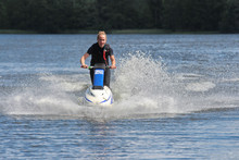 Action Photo Young Woman On Jet Ski.
