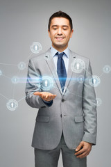 Canvas Print - happy businessman in suit showing network contacts