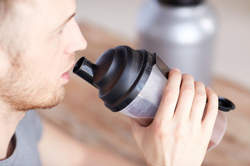 Wall Mural - close up of man drinking protein shake