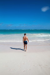 Wall Mural - Young sporty man goes to the ocean