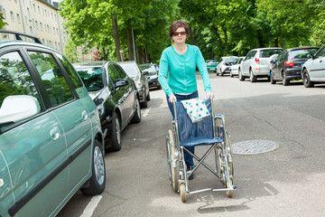 Wall Mural - Caregiver pushes wheelchair