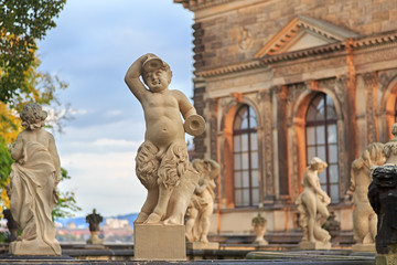 Closeup stone statue of child faunus at Zwinger palace in Dresde