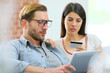 © goodluz - Couple at home shopping on internet