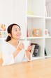 © taka - young asian woman relaxing in living room