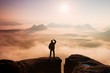 © rdonar - Man stands on peak of sandstone rock in national park