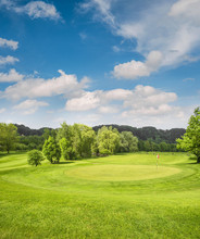 Golf Course Landscape. Field With Green Grass, Trees, Blue Sky