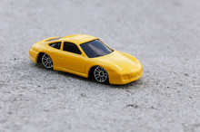 Yellow Toy Car Close-up On The Road