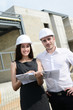 © W PRODUCTION - two foreman architect on building construction site with blueprint