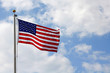 American Flag in front of Cloudy Blue Sky
