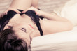 © Voyagerix - Seductive woman in lingerie on bed.