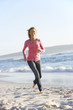© Monkey Business - Young Woman Running Along Sandy Beach On Holiday
