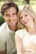 © Monkey Business - Portrait Of Young Couple Relaxing In Countryside
