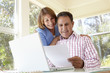 © Monkey Business - Senior Hispanic Couple Working In Home Office