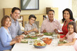 © Monkey Business - Extended Hispanic Family Enjoying Meal At Home