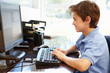 © Monkey Business - Young boy using computer at home