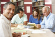 © Monkey Business - Mature students working in library