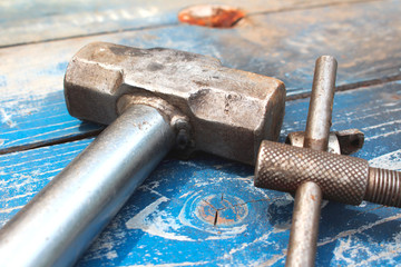 Hammer tool on wood background black and white