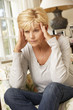 © Monkey Business - Unhappy Mature Woman Sitting On Sofa At Home
