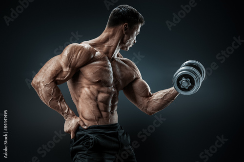 Fotografie, Obraz Power athletic man bodybuilder doing exercises with dumbbell