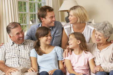 Wall Mural - Multi Generation Family Group Sitting On Sofa Indoors