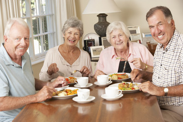 Wall Mural - Group Of Senior Couples Enjoying Meal Together