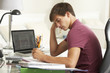 © Monkey Business - Teenage Boy Studying At Desk In Bedroom