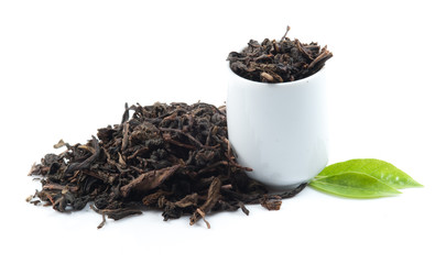 Black tea with green leaf isolated on white