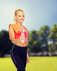 Poster - smiling sporty woman with water bottle and towel