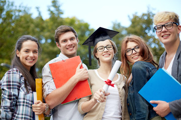 Poster - group of smiling students with diploma and folders