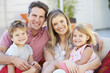 © Monkey Business - Family Sitting  On Garden Seat Together