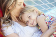 © Monkey Business - Mother And Daughter Relaxing In Garden Hammock Together