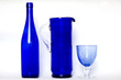 blue bottle and a glass of blue on a white background