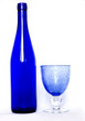 blue bottle and a glass of blue on a white background