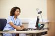 © Monkey Business - Female Nurse Working At Desk In Office