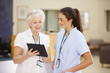 © Monkey Business - Female Consultant In Meeting With Nurse Using Digital Tablet
