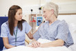 © Monkey Business - Nurse Sitting By Female Patient's Bed In Hospital