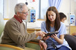 © Monkey Business - Man Having Chemotherapy With Nurse Using Digital Tablet