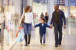 Child On Trip To Shopping Mall With Parents