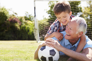 Canvas Print - Portrait Of Grandfather And Grandson With Football