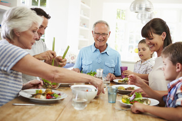 Canvas Print - Multi Generation Family Eating Meal Around Kitchen Table