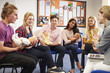 © Monkey Business - Teacher Helping Students Taking Childcare Course