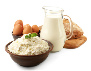 Wall Mural - Dairy products in pottery, glass jug of milk, eggs and loaf of bread isolated on white