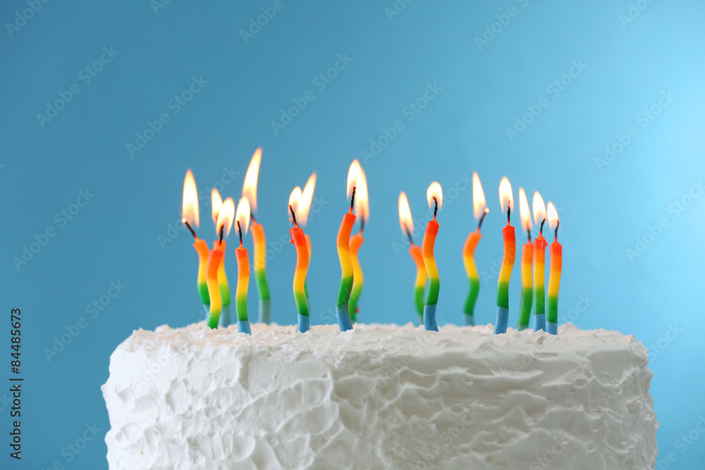 Birthday cake with candles on color background