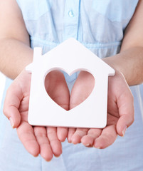 Poster - Female hands with small model of house, closeup