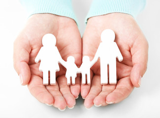 Wall Mural - Female hands holding toy family, closeup