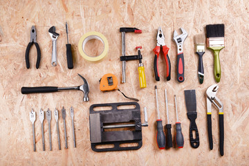 Set of tools on plywood, top view