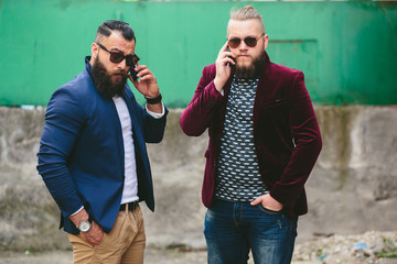 Two bearded businessman looking at phone