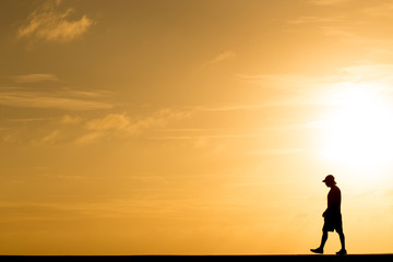 Wall Mural - Silhouette people walking at sunset